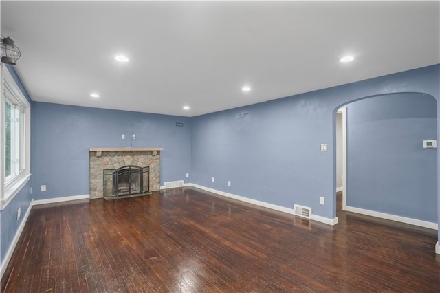 1809 Rosedale St, Verona, PA 15147 - unfurnished living room with arched walkways, wood-type flooring, a stone fireplace, and recessed lighting