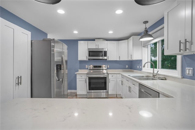 1809 Rosedale St, Verona, PA 15147 - kitchen featuring appliances with stainless steel finishes, white cabinets, light stone counters, hanging light fixtures, and recessed lighting
