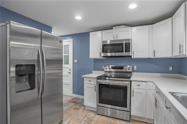 1809 Rosedale St, Verona, PA 15147 - kitchen featuring stainless steel appliances, light countertops, light stone finish floors, white cabinets, and recessed lighting