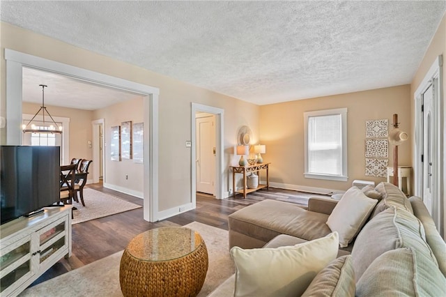 811 Bayridge Ave, Brookline, PA 15226 - living area with dark wood-type flooring, a chandelier, and a textured ceiling