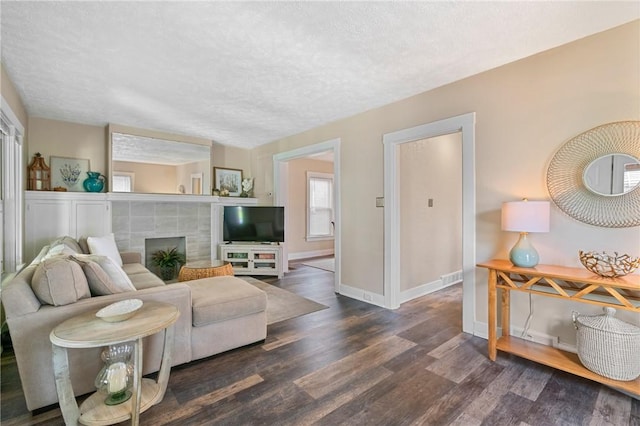 811 Bayridge Ave, Brookline, PA 15226 - living area featuring wood finished floors, a textured ceiling, and a fireplace
