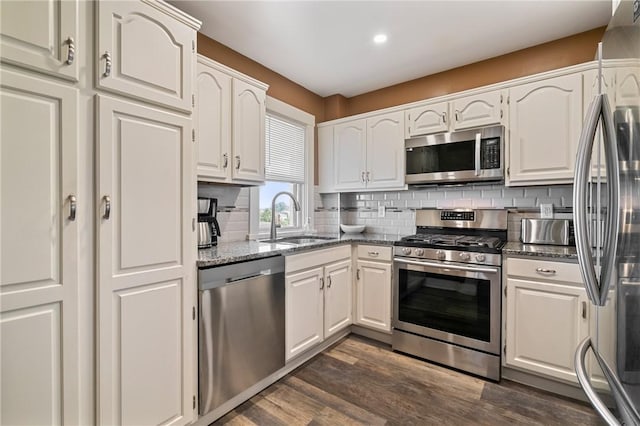 811 Bayridge Ave, Brookline, PA 15226 - kitchen with appliances with stainless steel finishes, dark stone counters, white cabinetry, tasteful backsplash, and dark wood-type flooring