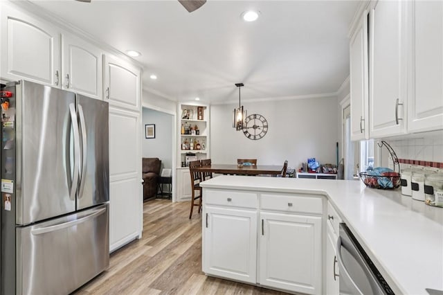 328 Chestnut Dr, Center Twp, PA 16001 - kitchen with stainless steel appliances, a peninsula, ornamental molding, white cabinetry, and light countertops