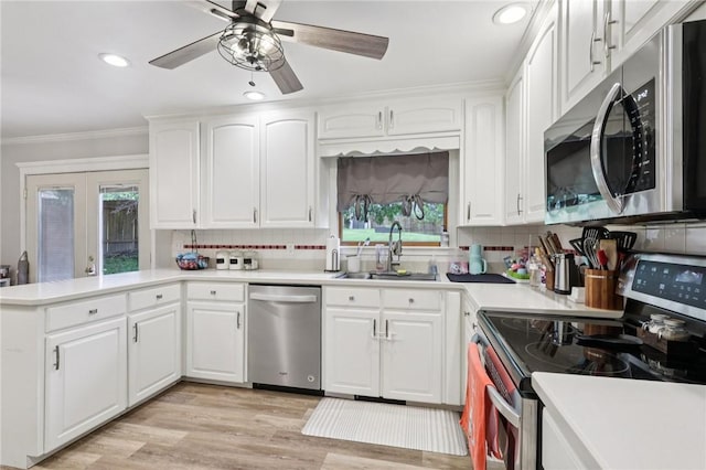 328 Chestnut Dr, Center Twp, PA 16001 - kitchen with appliances with stainless steel finishes, a peninsula, crown molding, plenty of natural light, and decorative backsplash
