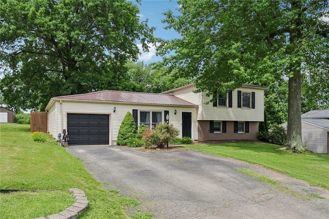 328 Chestnut Dr, Center Twp, PA 16001 - tri-level home featuring a garage, asphalt driveway, a front yard, and a metal roof