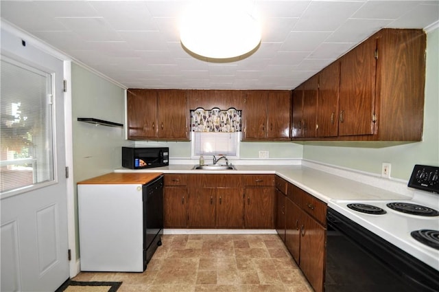 4632 Greensprings Ave, West Mifflin, PA 15122 - kitchen featuring black appliances, light countertops, and brown cabinets