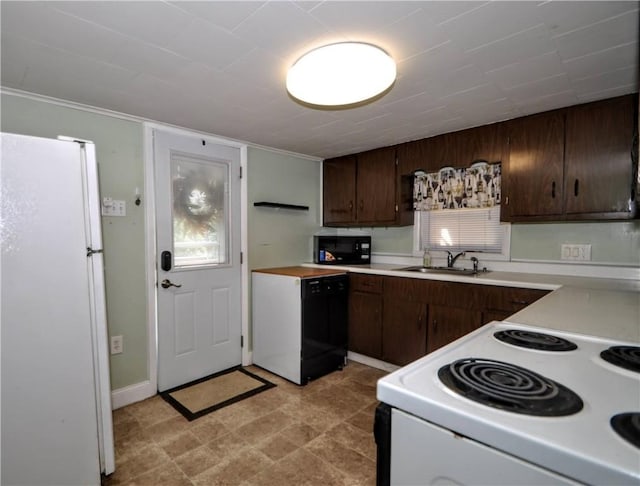 4632 Greensprings Ave, West Mifflin, PA 15122 - kitchen with black appliances, light countertops, and dark brown cabinets