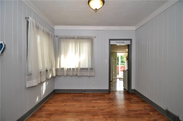 4632 Greensprings Ave, West Mifflin, PA 15122 - spare room featuring wood finished floors, wood walls, and ornamental molding