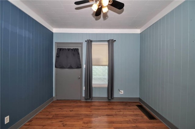 4632 Greensprings Ave, West Mifflin, PA 15122 - unfurnished room featuring wood finished floors, a ceiling fan, and wood walls