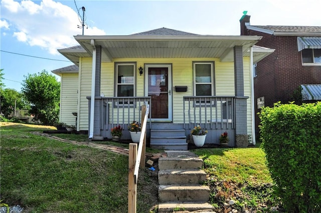 4632 Greensprings Ave, West Mifflin, PA 15122 - bungalow-style house featuring covered porch, a front lawn, and a shingled roof
