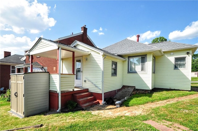 4632 Greensprings Ave, West Mifflin, PA 15122 - rear view of house with a lawn and roof with shingles