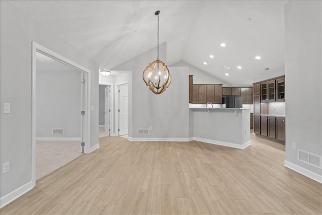 103 Spring Valley Dr, Jackson Twp, PA 16063 - unfurnished living room with a chandelier, light wood finished floors, vaulted ceiling, and recessed lighting