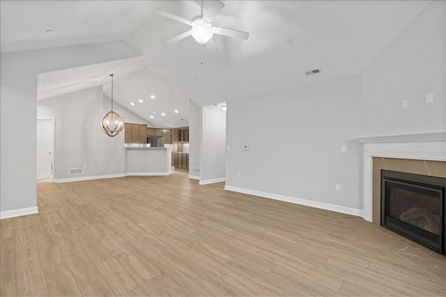 103 Spring Valley Dr, Jackson Twp, PA 16063 - unfurnished living room with lofted ceiling, ceiling fan, a fireplace, a chandelier, and light wood-style floors