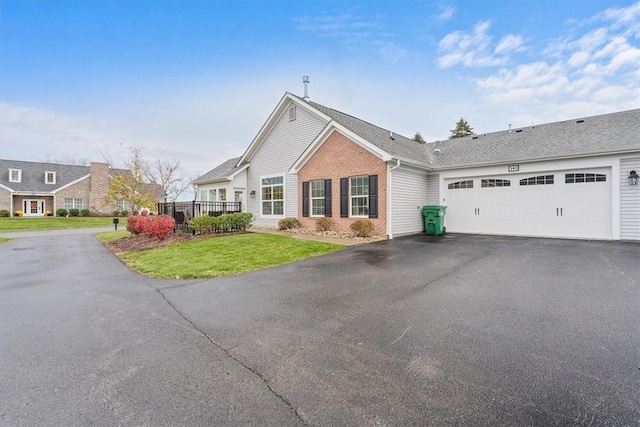 103 Spring Valley Dr, Jackson Twp, PA 16063 - single story home with asphalt driveway, brick siding, a garage, and a front lawn