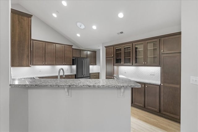 103 Spring Valley Dr, Jackson Twp, PA 16063 - kitchen with high quality fridge, a peninsula, light stone countertops, lofted ceiling, and backsplash