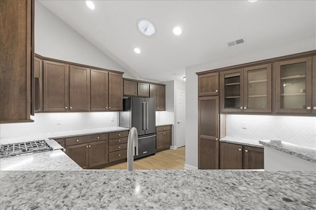 103 Spring Valley Dr, Jackson Twp, PA 16063 - kitchen with high end fridge, light wood finished floors, backsplash, vaulted ceiling, and light stone counters