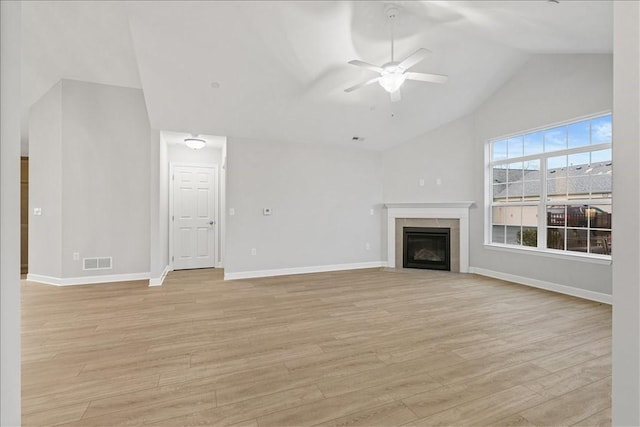 103 Spring Valley Dr, Jackson Twp, PA 16063 - unfurnished living room featuring a ceiling fan, vaulted ceiling, light wood-type flooring, and a tile fireplace