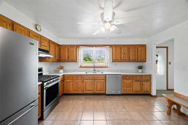 2812 Ridge Road Ext, Economy, PA 15005 - kitchen featuring appliances with stainless steel finishes, under cabinet range hood, ceiling fan, brown cabinets, and light countertops