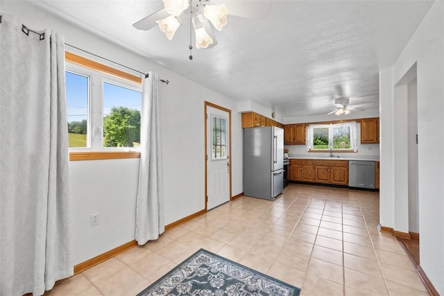 2812 Ridge Road Ext, Economy, PA 15005 - kitchen featuring appliances with stainless steel finishes, a ceiling fan, brown cabinets, light countertops, and light tile patterned floors