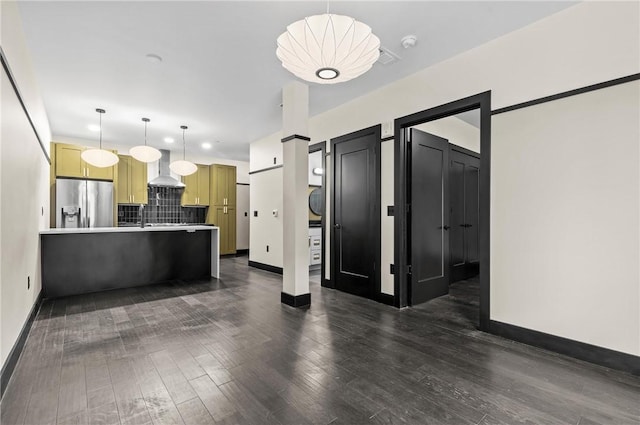 3725 Butler St Unit 306, Lawrenceville, PA 15201 - kitchen with stainless steel refrigerator with ice dispenser, a peninsula, wall chimney range hood, tasteful backsplash, and dark wood finished floors