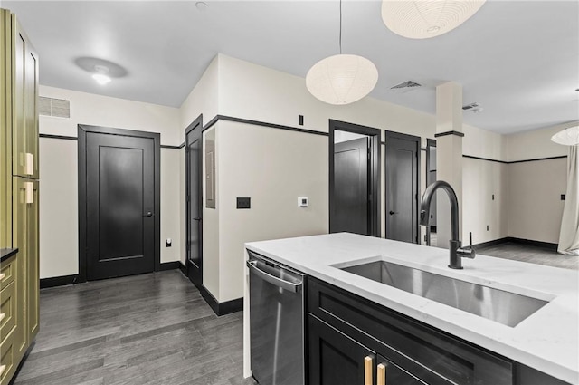 3725 Butler St Unit 306, Lawrenceville, PA 15201 - kitchen with stainless steel dishwasher, dark wood-style flooring, pendant lighting, dark cabinets, and light stone counters