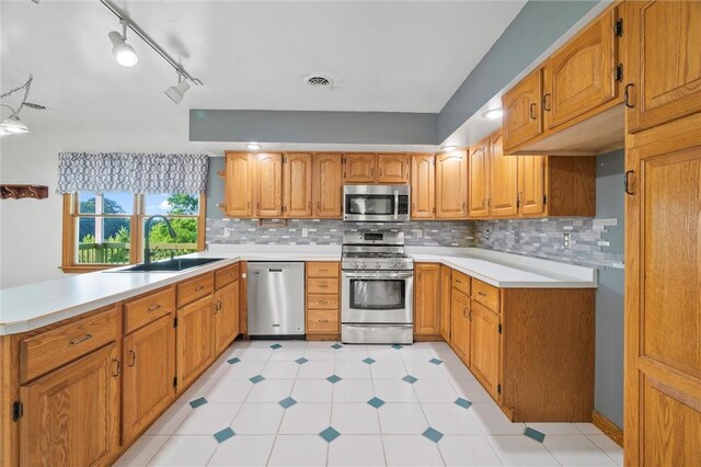 156 Riemer Rd, Buffalo Twp, PA 16055 - kitchen featuring appliances with stainless steel finishes, brown cabinetry, tasteful backsplash, and light countertops