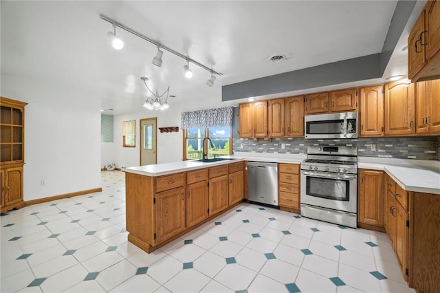 156 Riemer Rd, Buffalo Twp, PA 16055 - kitchen featuring appliances with stainless steel finishes, a peninsula, brown cabinetry, and light countertops