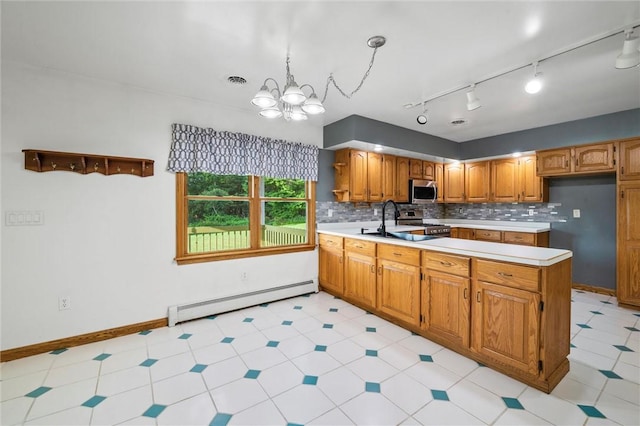 156 Riemer Rd, Buffalo Twp, PA 16055 - kitchen featuring a baseboard heating unit, a peninsula, light countertops, stainless steel appliances, and brown cabinetry