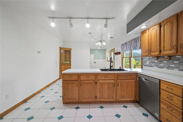 156 Riemer Rd, Buffalo Twp, PA 16055 - kitchen with stainless steel dishwasher, a peninsula, light countertops, and brown cabinetry