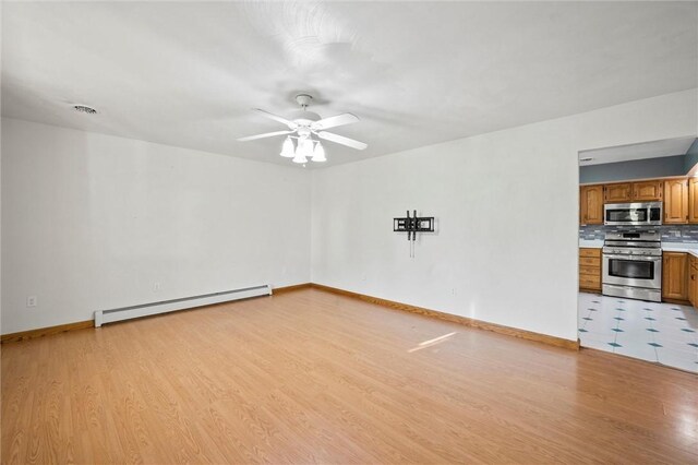 156 Riemer Rd, Buffalo Twp, PA 16055 - unfurnished living room with a baseboard heating unit, ceiling fan, and light wood-style floors