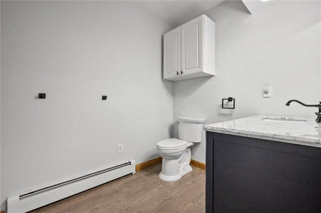 156 Riemer Rd, Buffalo Twp, PA 16055 - bathroom featuring baseboard heating, vanity, and wood finished floors