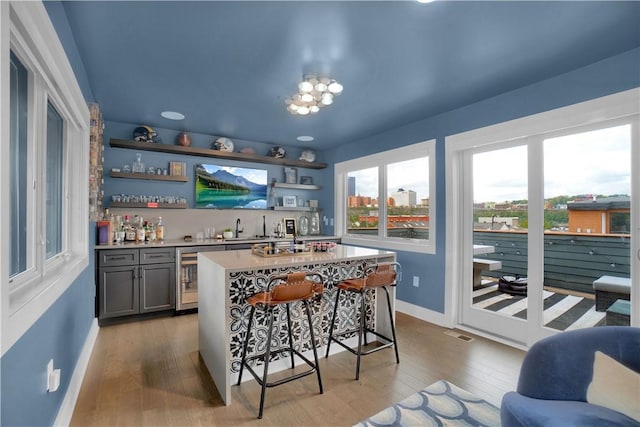 1817 Fox Way S, Side, PA 15203 - indoor wet bar with wine cooler, light wood-style flooring, and a chandelier