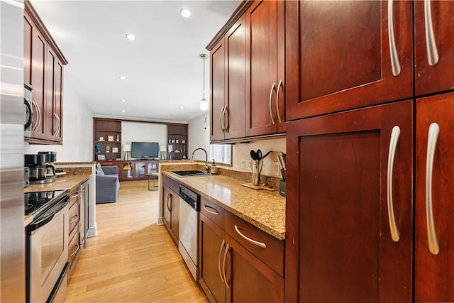 21 Enon Way S, Side, PA 15203 - kitchen with appliances with stainless steel finishes, light wood finished floors, light stone counters, open floor plan, and recessed lighting