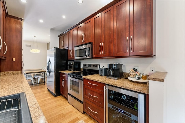 21 Enon Way S, Side, PA 15203 - kitchen featuring stainless steel appliances, wine cooler, light wood-style floors, recessed lighting, and decorative light fixtures