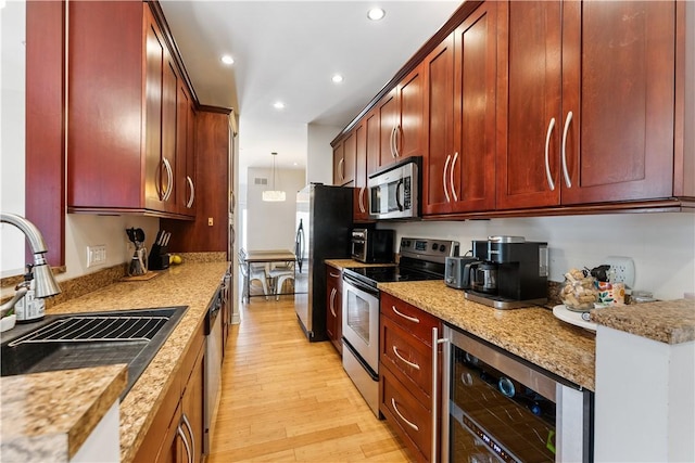 21 Enon Way S, Side, PA 15203 - kitchen with appliances with stainless steel finishes, beverage cooler, recessed lighting, light wood finished floors, and dark brown cabinets