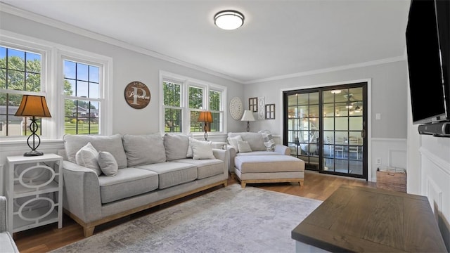 8609 Peters Rd, Cranberry Twp, PA 16066 - living room with wood finished floors, ornamental molding, and a wainscoted wall