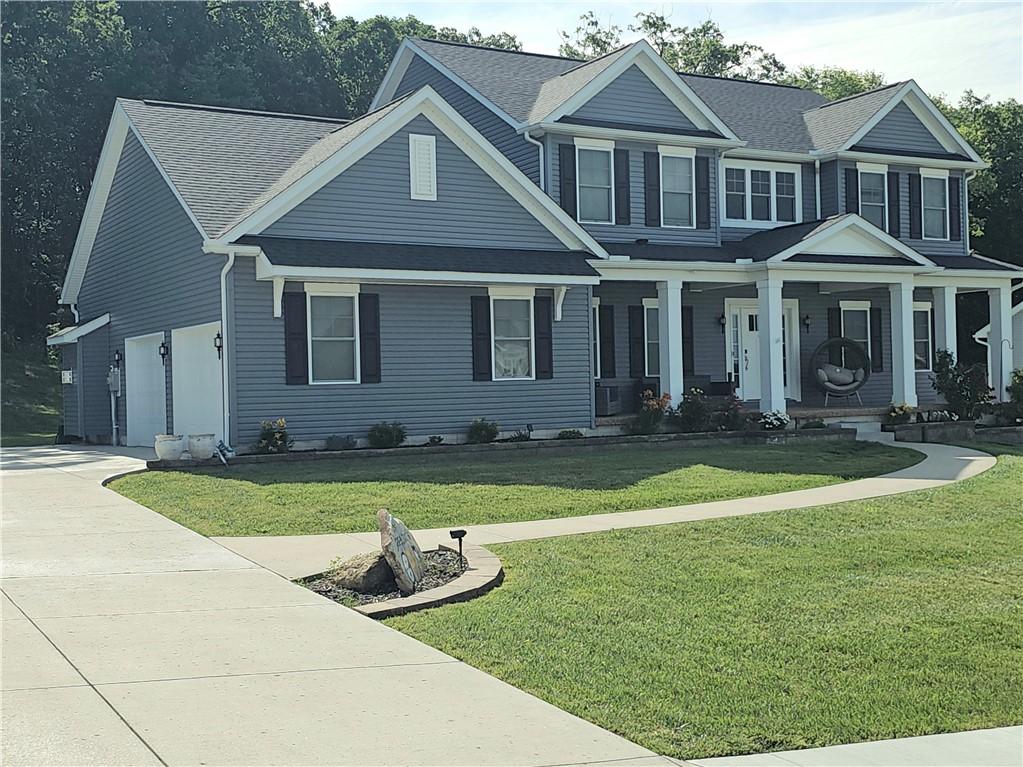 300 Crabapple Ln, North Sewickley Twp, PA 15010 - view of front facade with a porch, a front yard, concrete driveway, a garage, and a shingled roof