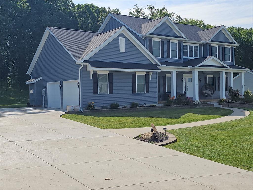300 Crabapple Ln, North Sewickley Twp, PA 15010 - view of front of home featuring driveway, a porch, a front yard, and an attached garage