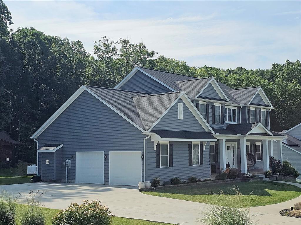 300 Crabapple Ln, North Sewickley Twp, PA 15010 - view of front facade featuring concrete driveway, a front yard, a porch, a garage, and a shingled roof
