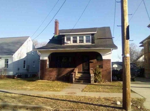 27 W Frederick St, Corry, PA 16407 - bungalow-style home featuring brick siding and a chimney