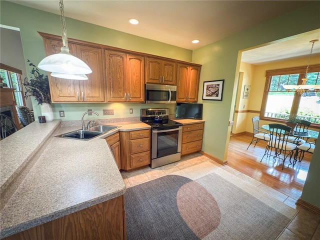 121 Covington Dr, Center Twp, PA 16001 - kitchen featuring stainless steel appliances, healthy amount of natural light, light countertops, hanging light fixtures, and recessed lighting