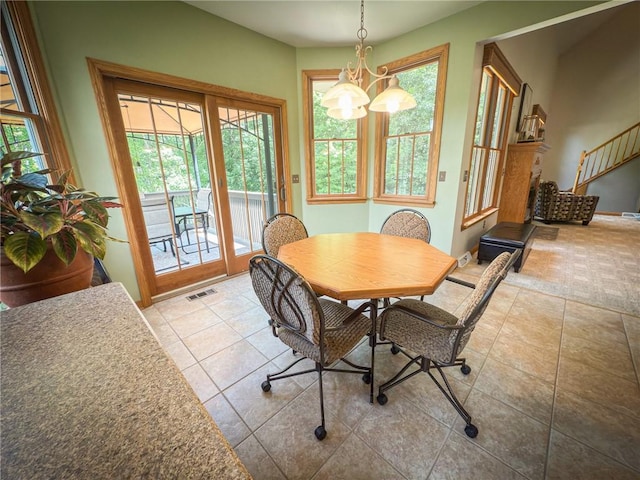 121 Covington Dr, Center Twp, PA 16001 - tiled dining space featuring a chandelier and stairway