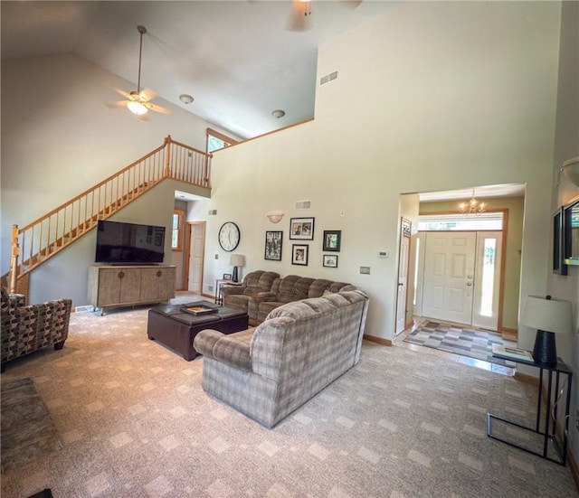 121 Covington Dr, Center Twp, PA 16001 - carpeted living room featuring a ceiling fan, high vaulted ceiling, stairs, and a chandelier