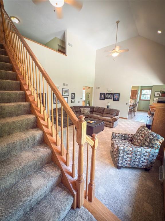 121 Covington Dr, Center Twp, PA 16001 - living room with ceiling fan, high vaulted ceiling, carpet flooring, and stairs