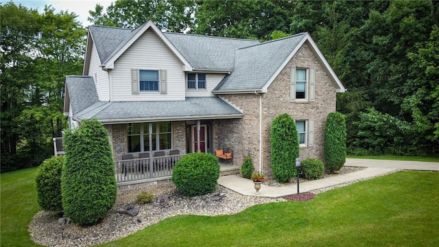 121 Covington Dr, Center Twp, PA 16001 - view of front of house with covered porch, a front lawn, and brick siding