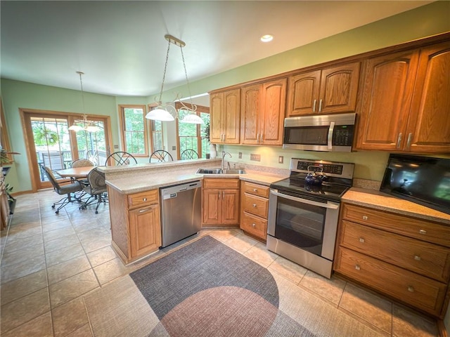 121 Covington Dr, Center Twp, PA 16001 - kitchen with appliances with stainless steel finishes, a peninsula, light countertops, brown cabinets, and recessed lighting