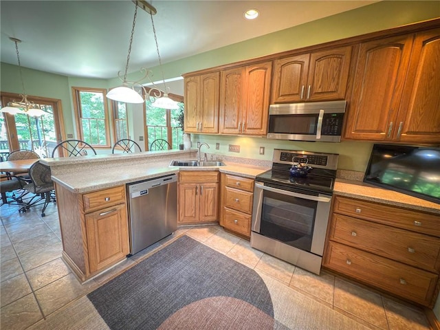 121 Covington Dr, Center Twp, PA 16001 - kitchen with stainless steel appliances, a peninsula, light countertops, brown cabinetry, and recessed lighting