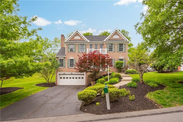 3001 Willowbrook Dr, South Fayette, PA 15017 - georgian-style home featuring brick siding, driveway, an attached garage, a front yard, and a chimney