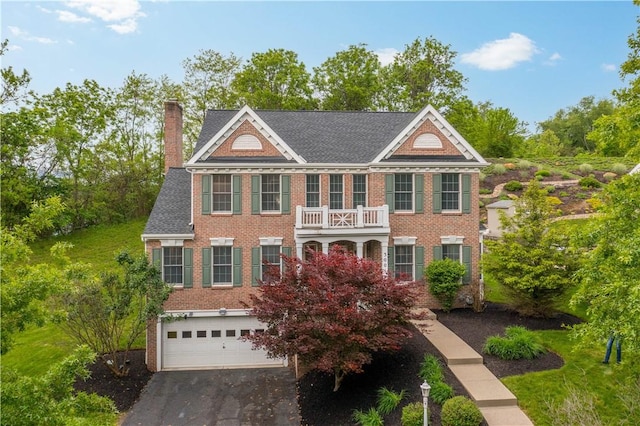 3001 Willowbrook Dr, South Fayette, PA 15017 - colonial-style house featuring a balcony, brick siding, a chimney, an attached garage, and driveway