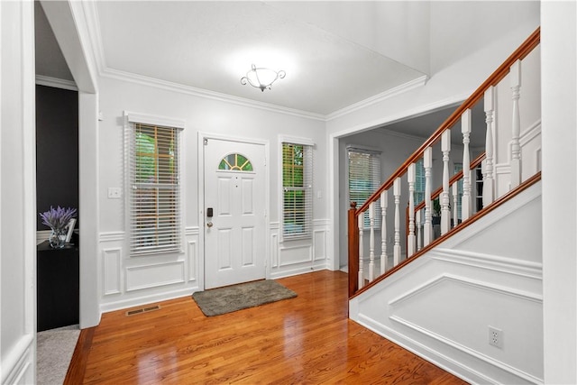3001 Willowbrook Dr, South Fayette, PA 15017 - entrance foyer featuring ornamental molding, wood finished floors, stairs, a decorative wall, and wainscoting